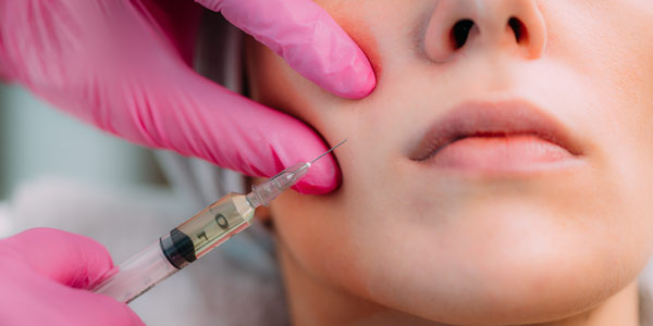 Young Female Receiving Dermal Filler Injection for Cheeks in Sycamore, IL | Nuvo Aesthetics Clinic