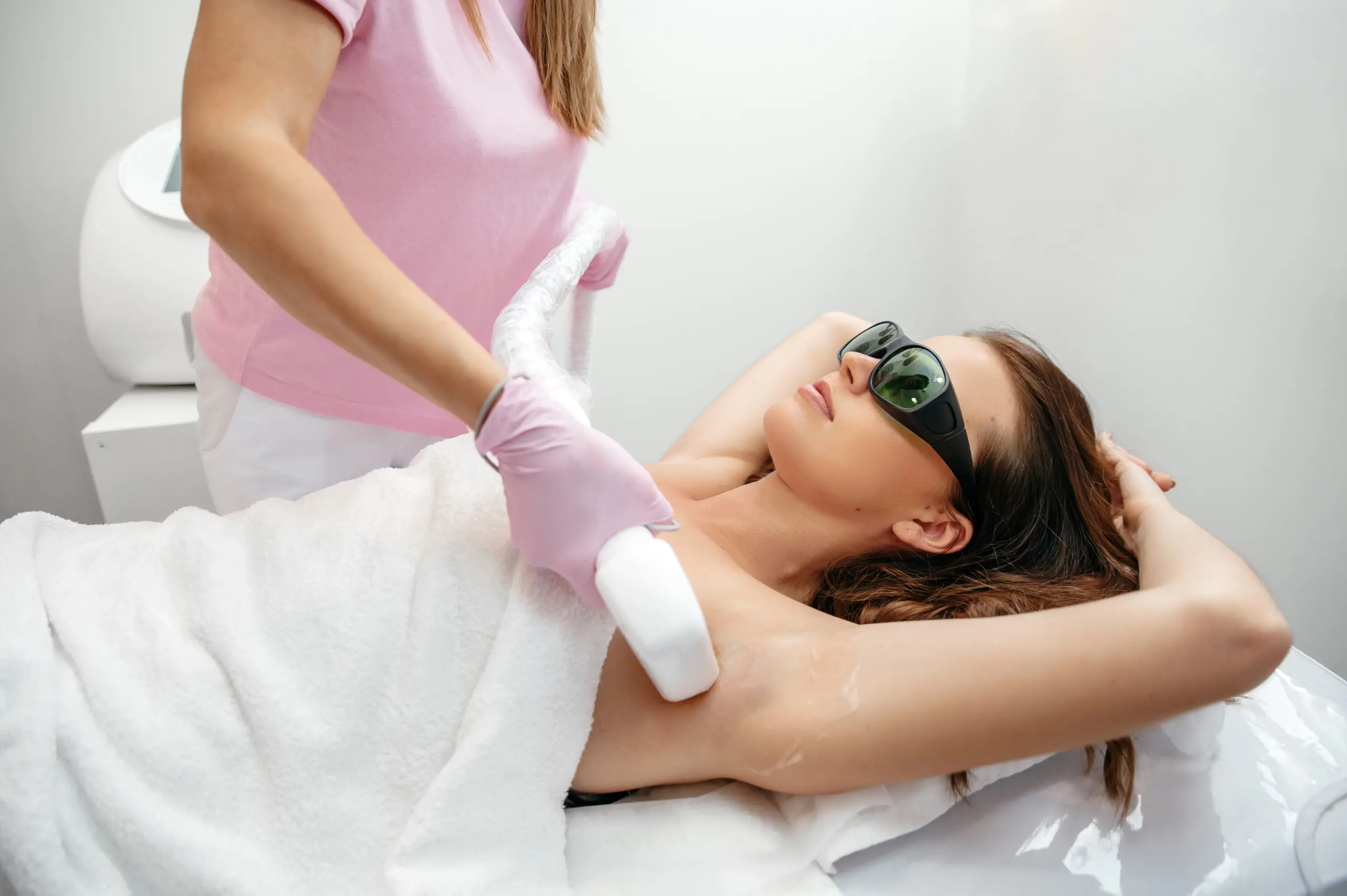 Woman receiving underarm laser hair removal treatment at nuvo aesthetics clinic