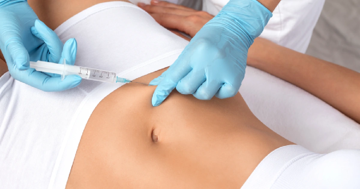 Practitioner Administering A Lipotropic Injection Into The Abdomen by Nuvo Aesthetics Clinic in Sycamore, IL